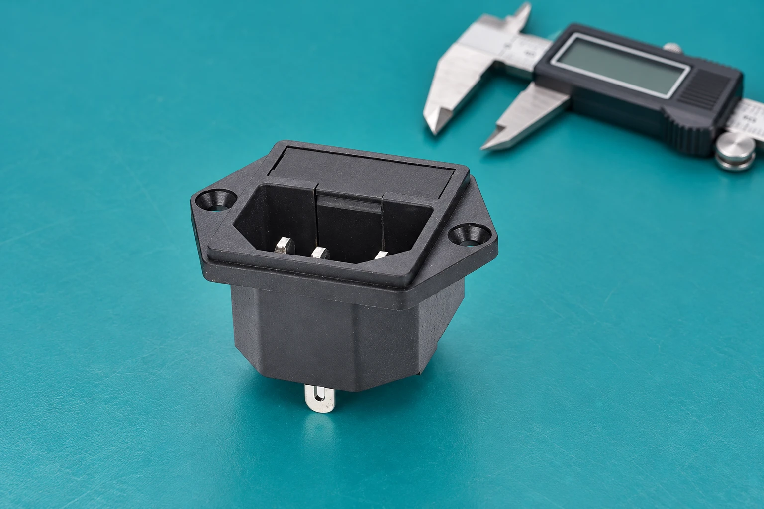 Loose screw-mounted IPZ inlet on a turquoise mat beside a detached caliper