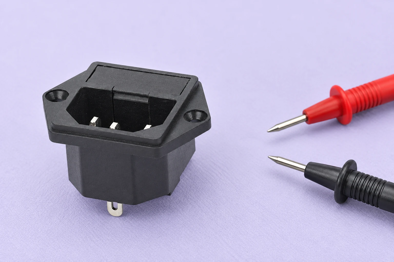 Isolated IPZ inlet on a lavender mat beside disconnected continuity probes