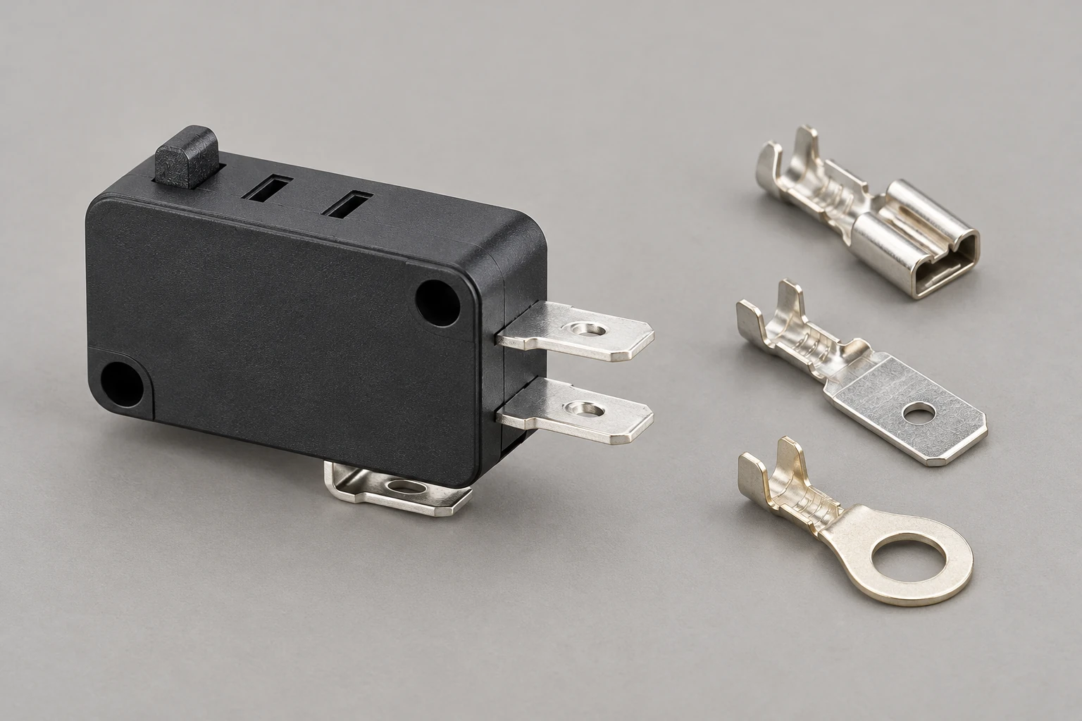 KW7 micro switch beside three separate loose connector specimens KW7 micro switch beside three separate loose connector specimens