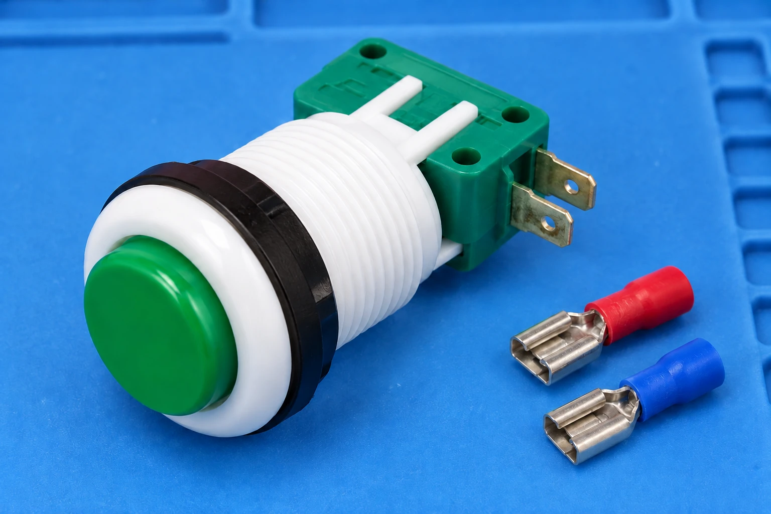 PBS-001 green housing and two rear quick-connect terminals on a blue inspection pad