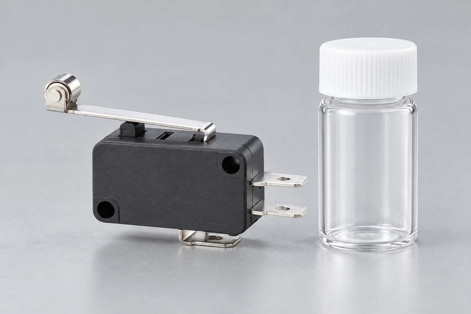 KW7 switch beside a closed empty sample vial; no composition test is shown